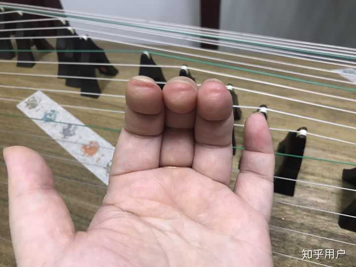 古筝左手按弦是用手指尖按,还是用手指与假指甲之间的缝隙按?