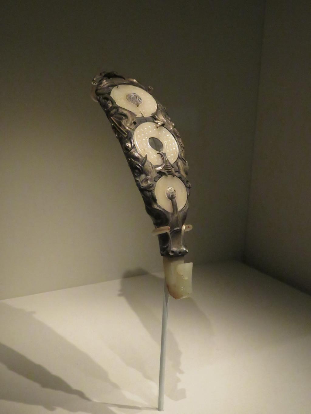 此件带钩由白银制成,器形较大,通体鎏金,钩身铸浮雕式的兽首和长尾鸟